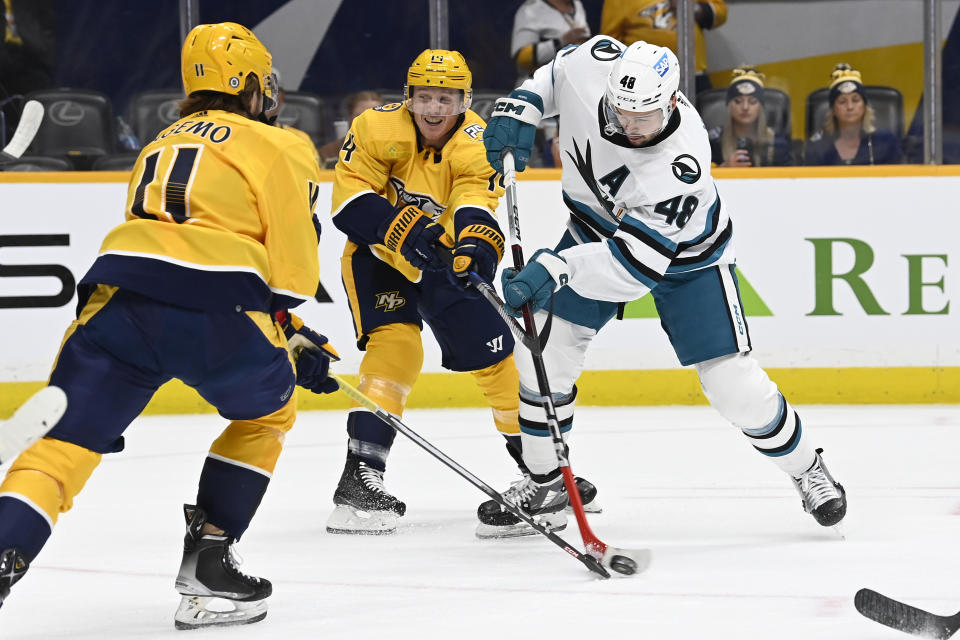 Nashville Predators' Samuel Fagemo (11) and Gustav Nyquist (14) block a shot by San Jose Sharks center Tomas Hertl (48) during the first period of an NHL hockey game Saturday, Oct. 21, 2023, in Nashville, Tenn. (AP Photo/Mark Zaleski)