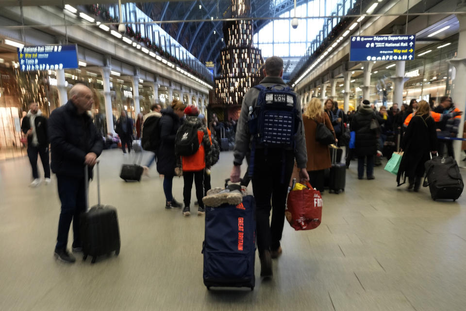 Travellers queue for the Eurostar trains at St Pancras Station in London, Friday, Dec. 22, 2023. Eurostar was hit Thursday by an unofficial strike in northern France, this led to the cancellation of most services. With full trains leading up to Christmas those travellers affected by the strike will have to find alternative ways to their destination. (AP Photo/Alastair Grant)