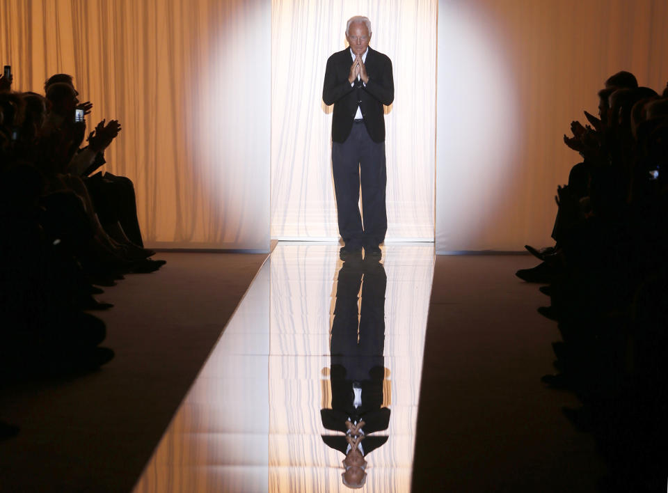 Fashion designer Giorgio Armani acknowledges applause following the presentation of the Giorgio Armani Prive's Haute Couture Fall-Winter 2013-2014 collection, Tuesday, July 2, 2013 in Paris. (AP Photo/Jacques Brinon)