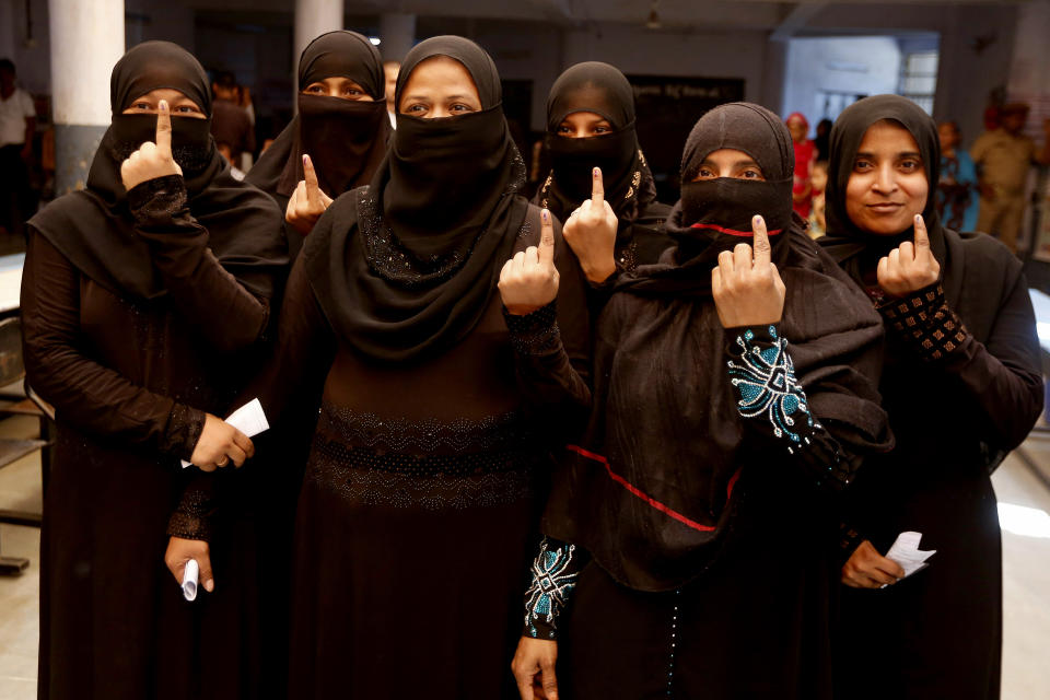 Indian muslim women show the indelible ink mark on their index fingers after casting their votes for general election in Ahmadabad, India, Tuesday, April 23, 2019. Indians are voting Tuesday in the third phase of the general elections with campaigning by Prime Minister Narendra Modi's Hindu nationalist party and the opposition marred by bitter accusations and acrimony. The voting over seven phases ends May 19, with counting scheduled for May 23. (AP Photo/Ajit Solanki)