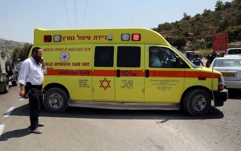 Ambulance is seen at the scene of an attack near the Jewish settlement of Dolev in the Israeli-occupied West Bank - Credit: REUTERS/Ammar Awad