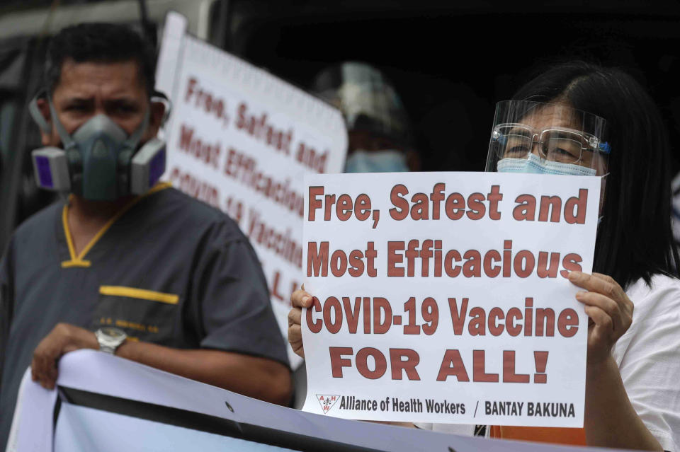 Health workers display slogans calling on the government to give them a vaccine with the safest, highest efficacy and effectivity during a a protest outside the Lung Center of the Philippines in Quezon city, Philippines on Monday, March 1, 2021. The Philippines launched a vaccination campaign Monday to contain one of Southeast Asia's worst coronavirus outbreaks but faces supply problems and public resistance, which it hopes to ease by inoculating top officials. (AP Photo/Aaron Favila)