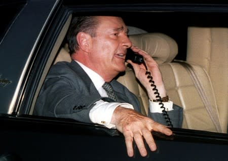 FILE PHOTO: Newly elected French President Jacques Chirac talks on his car phone during a motorcade thjough Pari..