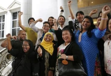 Activists celebrate overturning a sharia law against cross-dressing at the Appeals Court in the Palace of Justice in Putrajaya November 7, 2014. REUTERS/Olivia Harris