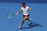 Li Na of China hits a return to Belinda Bencic of Switzerland during their women's singles match at the Australian Open 2014 tennis tournament in Melbourne January 15, 2014. REUTERS/Jason Reed