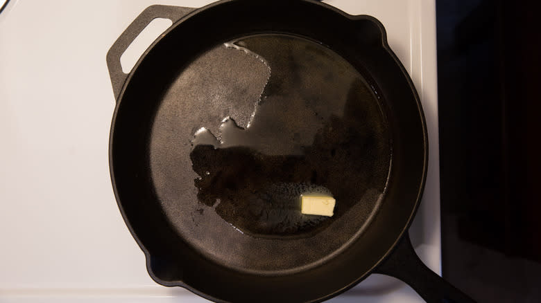 butter melting in iron pan 
