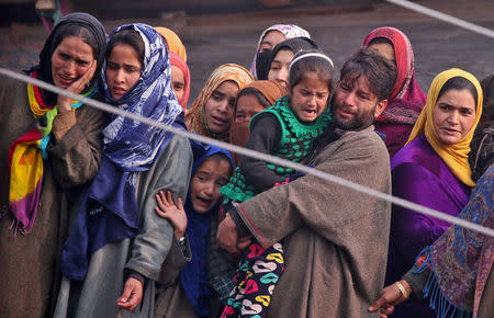 People mourn as they watch the body of Shahid Ahmad, a suspected militant, who according to police was killed in a gun battle with Indian security forces, before his funeral in Kawani village in south Kashmir's Pulwama district November 23, 2018. REUTERS/Danish Ismail