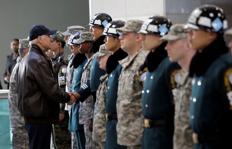 FILE PHOTO: U.S. Vice President Joe Biden shakes hands with South Korean and U.S. soldiers during a tour of the DMZ, the military border separating the two Koreas, in Panmunjom