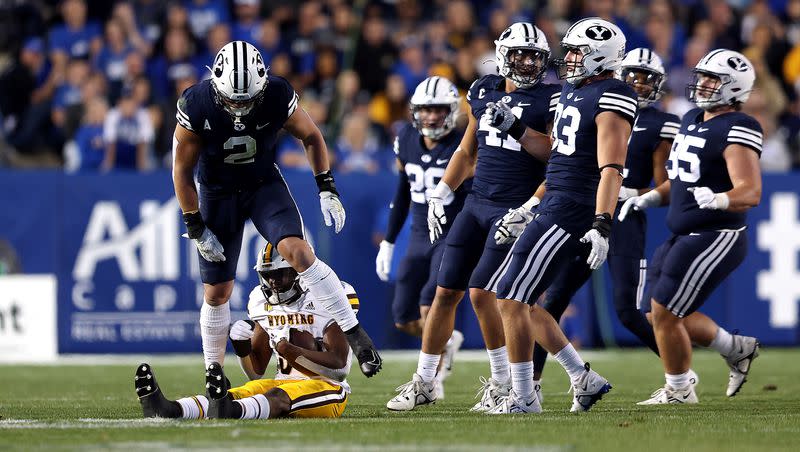BYU linebacker Ben Bywater (2) steps over Wyoming running back Dawaiian McNeely after a play at LaVell Edwards Stadium in Provo on Saturday, Sept. 24, 2022. Bywater has led the Cougars in tackles the last two seasons and will be back in 2023.
