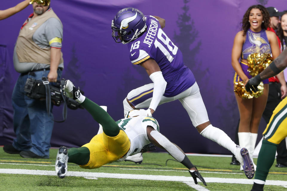 Minnesota Vikings wide receiver Justin Jefferson (18) breaks a tackle by Green Bay Packers safety Adrian Amos during a 36-yard touchdown reception during the first half of an NFL football game, Sunday, Sept. 11, 2022, in Minneapolis. (AP Photo/Bruce Kluckhohn)