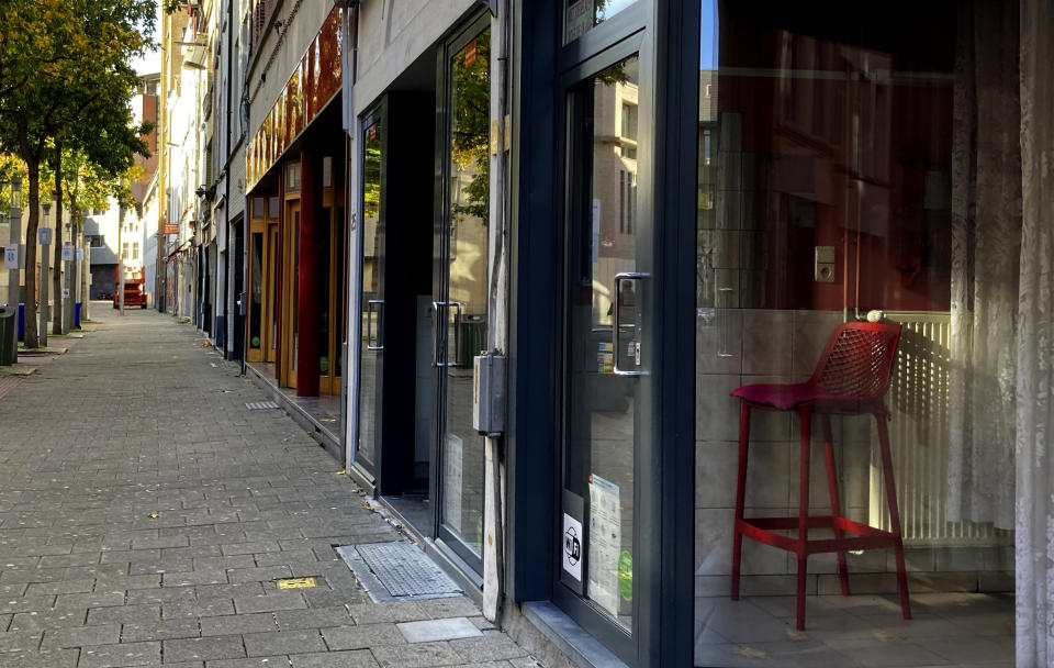 A chair inside of a sex-workers booth stands empty in Antwerp, Belgium, Tuesday, Nov. 3, 2020. Several European countries, including Belgium, are tightening restrictions this week, as authorities across the continent scramble to slow a rapid rise in coronavirus infections that threatens to overwhelm their health care systems. With prostitution banned many sex workers have depleted their savings and are having a hard time affording even basic necessities. (AP Photo/Virginia Mayo)