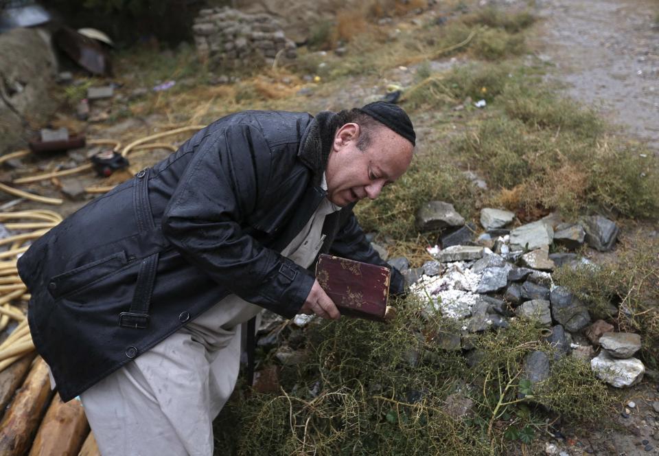 Zabulon Simantov, an Afghan Jew, prays at a Jewish cemetery in Kabul