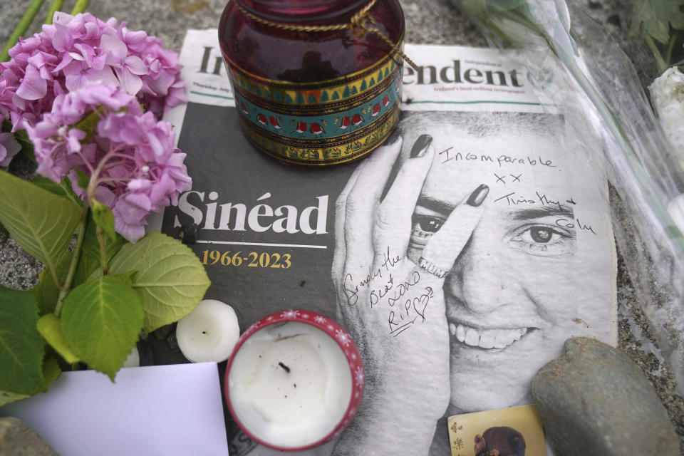 Floral tributes laid outside Sinead O'Connor's former home in Bray, Co Wicklow, Ireland, Thursday, July 27, 2023 after her death at the age of 56. The Met Police said O’Connor was found unresponsive in a home in southeast London. They did not say how she died but said her death was not considered suspicious. (Brian Lawless/PA via AP)