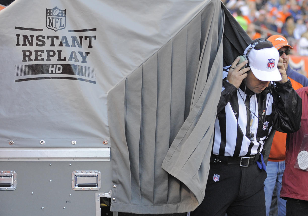 FILE - In this Dec. 23, 2012 file photo, referee Al Riverson steps out of the instant replay tent during the second quarter of an NFL football game between the Denver Broncos and the Cleveland Browns, in Denver. League owners passed a rule Tuesday, March 25, 2014, allowing referees to consult with director of officiating Dean Blandino and his staff to help determine whether a call should be upheld or overturned. NFL officials said the change should speed up the process. (AP Photo/Jack Dempsey, File)