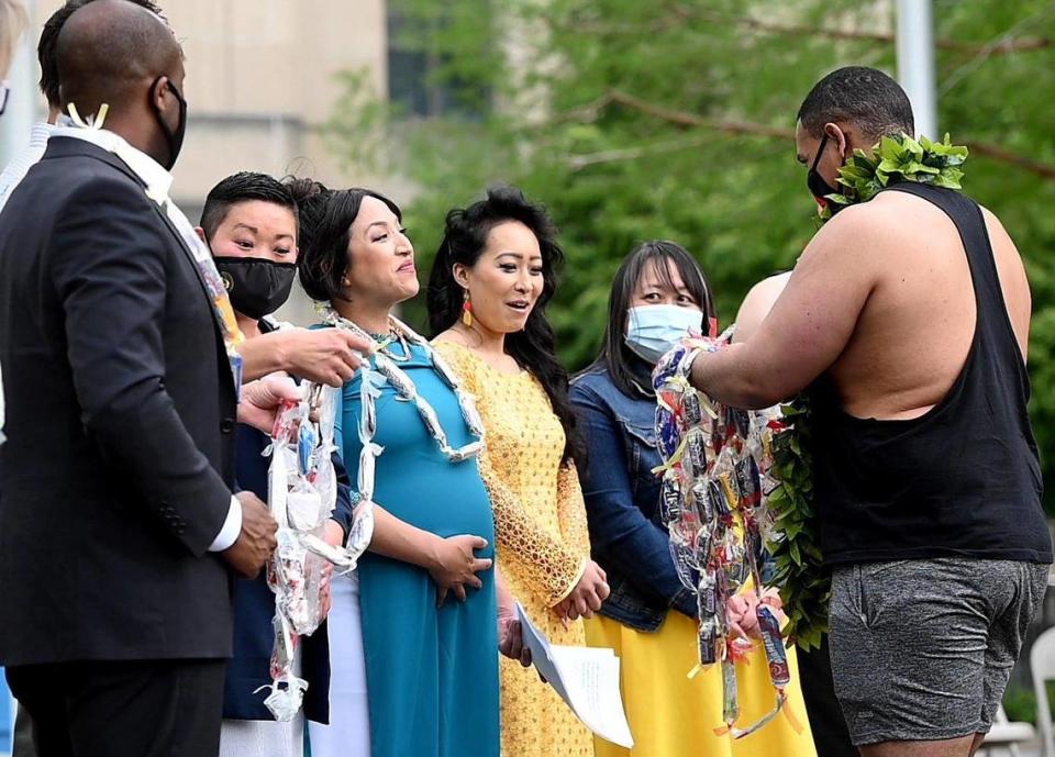 Kansas City officially recognized May as Asian American Pacific Islander Heritage Month. AAPI community members and supporters turned out to celebrate at Ilus W. Davis Park on Saturday, May 8, 2021. While the proclamation was being read, Justice Horn (right) hands out leis made of candy to event organizers and speakers: from left, Kansas City Mayor Quinton Lucas, Missouri State Rep. Emily Weber, Bety Le Shackelford, Jackie Nguyen and PaKou Her.