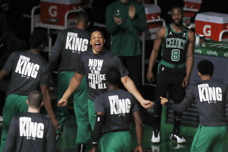 Boston Celtics' Grant Williams, center, rallies with teammates before an NBA basketball game against the New York Knicks, Sunday, Jan. 17, 2021, in Boston. (AP Photo/Michael Dwyer)