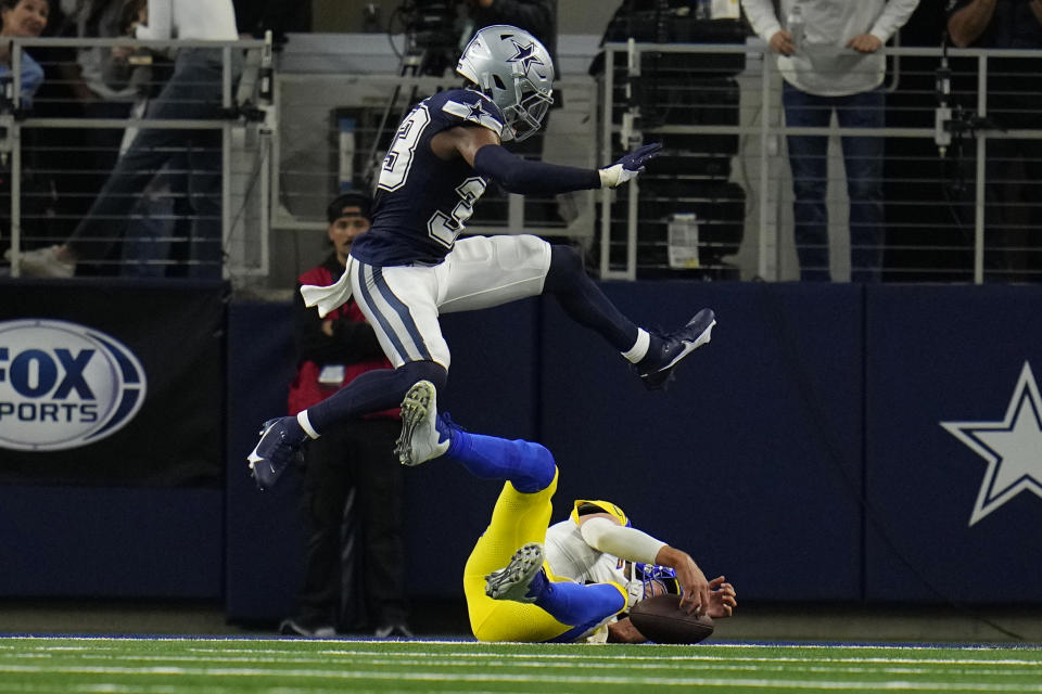 Los Angeles Rams quarterback Matthew Stafford, bottom, scores a two-point conversion under Dallas Cowboys Damone Clark during the second half of an NFL football game Sunday, Oct. 29, 2023, in Arlington, Texas. (AP Photo/Julio Cortez)