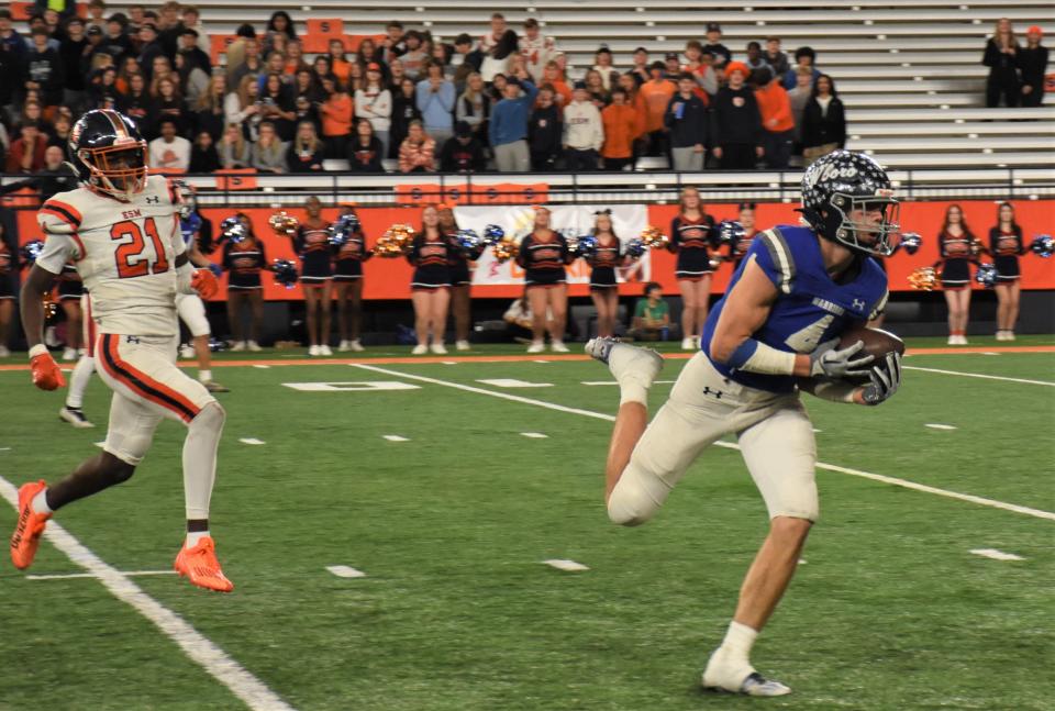 Whitesboro Warrior Anthony Dorozynski (4) runs with the ball after catching a pass against East Syracuse-Minoa during Section III's Class A championship game in the JMA Wireless Dome Nov. 11. The Warriors need win Friday to get back to the dome for next weekend's state championship game.