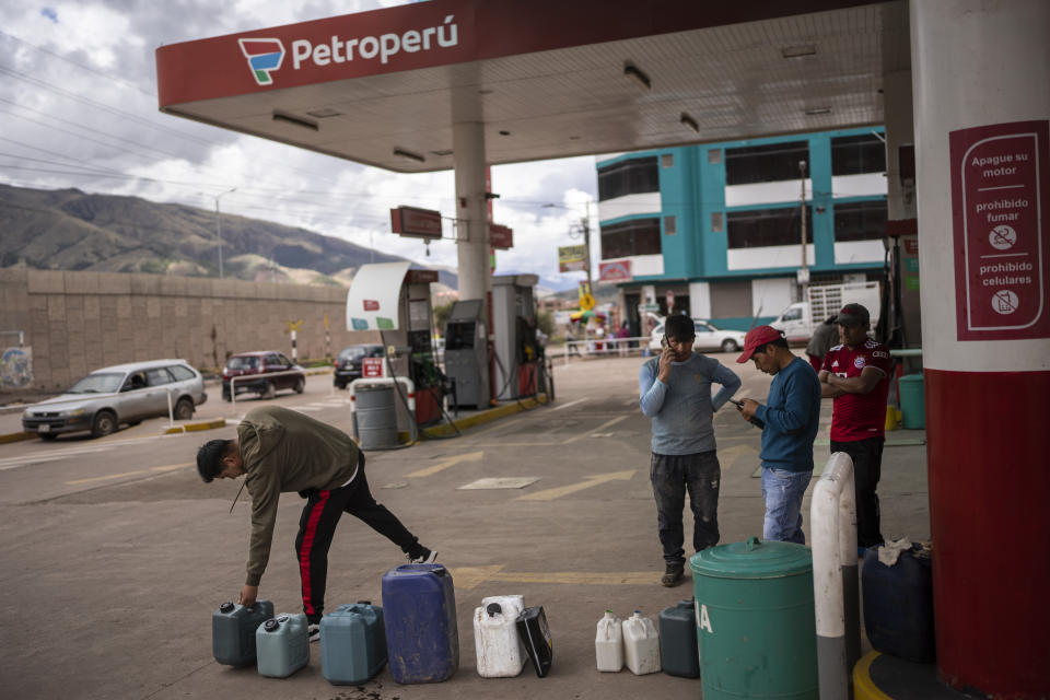 A man places a gas tank to mark his place in line while waiting for a gasoline station to open, Cusco, Peru, Friday, Jan. 27, 2023. Peru's president called on Congress Friday to approve a proposal to move elections forward to late this year, a marked concession from the leader who has been facing daily protests that have left almost 60 people dead. (AP Photo/Rodrigo Abd)