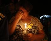 A resident holding a candle cries in front of the house of Colombian Nobel Prize laureate Gabriel Garcia Marquez in Aracataca April 17, 2014. Garcia Marquez, the Colombian author whose beguiling stories of love and longing brought Latin America to life for millions of readers and put magical realism on the literary map, died on Thursday. He was 87. Garcia Marquez died at his home in Mexico City, a source close to his family said. Known affectionately to friends and fans as "Gabo", Garcia Marquez was Latin America's best-known author and most beloved author and his books have sold in the tens of millions.