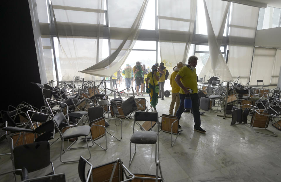 Protesters, supporters of Brazil's former President Jair Bolsonaro, storm the National Congress building in Brasilia, Brazil, Sunday, Jan. 8, 2023. (AP Photo/Eraldo Peres)