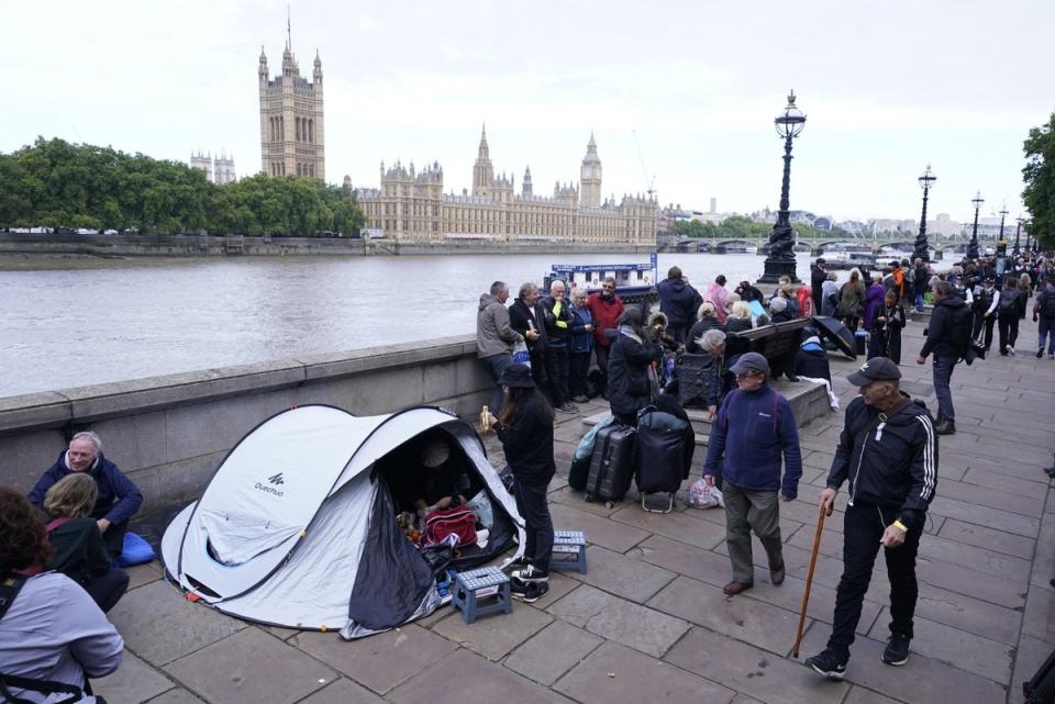 Members of the public join the queue on the South Bank, as they wait to view Queen Elizabeth II lying in state ahead of her funeral on Monday (PA)