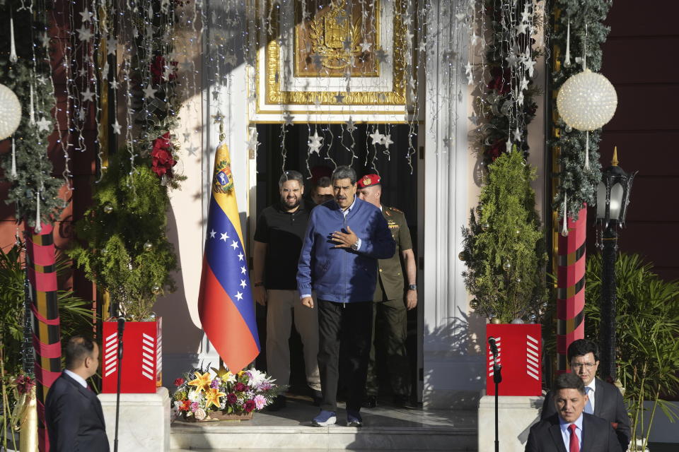 Venezuelan President Maduro exits a door at Miraflores presidential palace to receive Alex Saab in Caracas, Venezuela, Wednesday, Dec. 20, 2023. The United States freed Saab, who was arrested on a U.S. warrant for money laundering in 2020, in exchange for the release of 10 Americans imprisoned in Venezuela, U.S. officials said Wednesday. (AP Photo/Matias Delacroix)