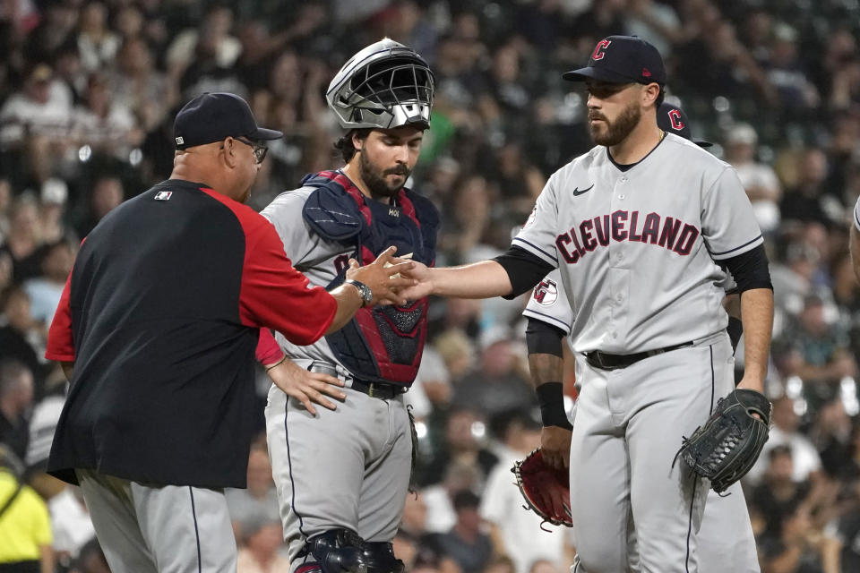 Cleveland Guardians manager Terry Francona, left, pulls starting pitcher Aaron Civale as catcher Austin Hedges watches during the sixth inning of the team's baseball game against the Chicago White Sox on Tuesday, Sept. 20, 2022, in Chicago. (AP Photo/Charles Rex Arbogast)