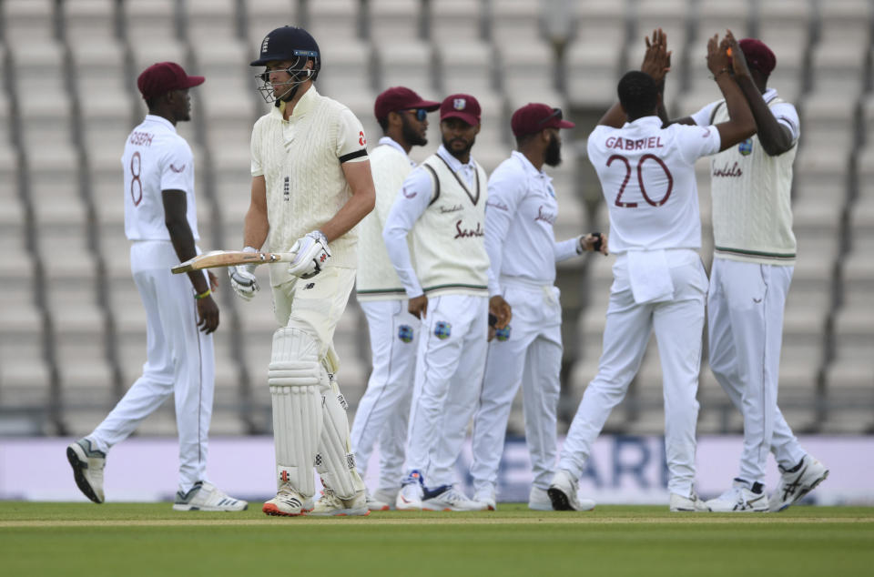 England's Dom Sibley, second left, leaves the field after being dismissed by West Indies' Shannon Gabriel, second right, during the first day of the 1st cricket Test match between England and West Indies, at the Ageas Bowl in Southampton, England, Wednesday July 8, 2020. (Mike Hewitt/Pool via AP)