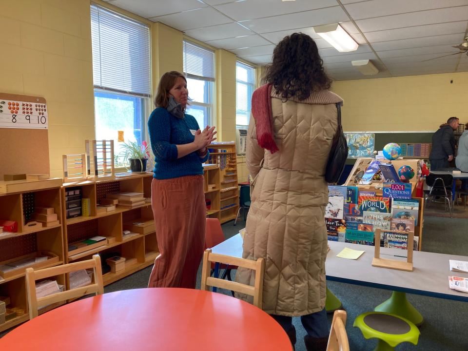 Sasha Skau speaks with a prospective parent at a Feb. 4, 2023 open house for Mountain City Public Montessori in downtown Asheville.