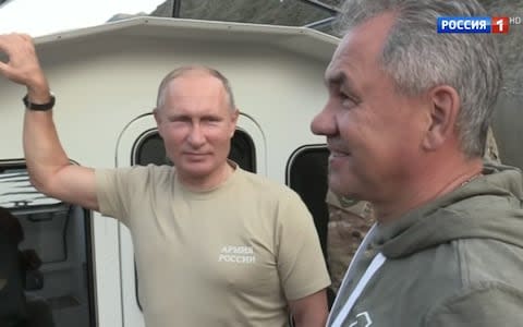 Mr Putin goes boating with defence minister Sergei Shoigu in footage shown on the new programme - Credit: YouTube