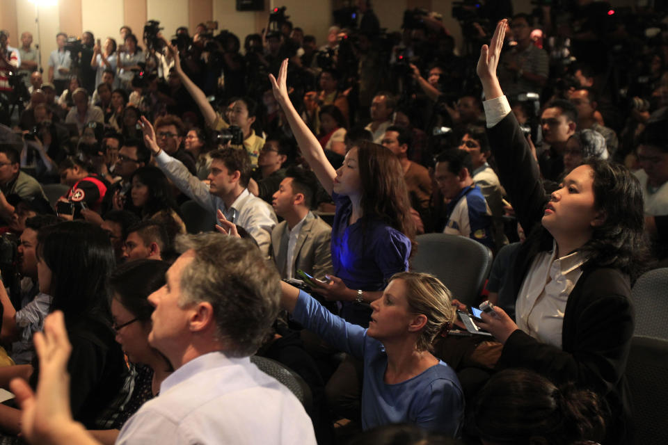 Journalists raise their hands to ask questions during a press conference at a hotel in Sepang, Malaysia, Wednesday, March 12, 2014. More than four days after the Malaysian jetliner went missing en route to Beijing, authorities acknowledged Wednesday they didn't know which direction the plane carrying 239 passengers was heading when it disappeared, vastly complicating efforts to find it. (AP Photo/Lai Seng Sin)