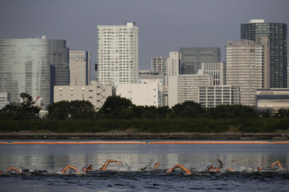 FILE - In this Aug. 11, 2019, file photo, athletes compete in a marathon swimming test event at Odaiba Marine Park, a venue for marathon swimming and triathlon at the Tokyo 2020 Olympics, in Tokyo. The IOC moved next year’s Tokyo Olympic marathons and race walks out of the Japanese capital to avoid the stifling heat and humidity. Some swimmers and an 11,000-member coaching body want similar treatment: find an alternative to the distance-swimming venue in Tokyo Bay known as the “Odaiba Marine Park.”(AP Photo/Jae C. Hong, File)