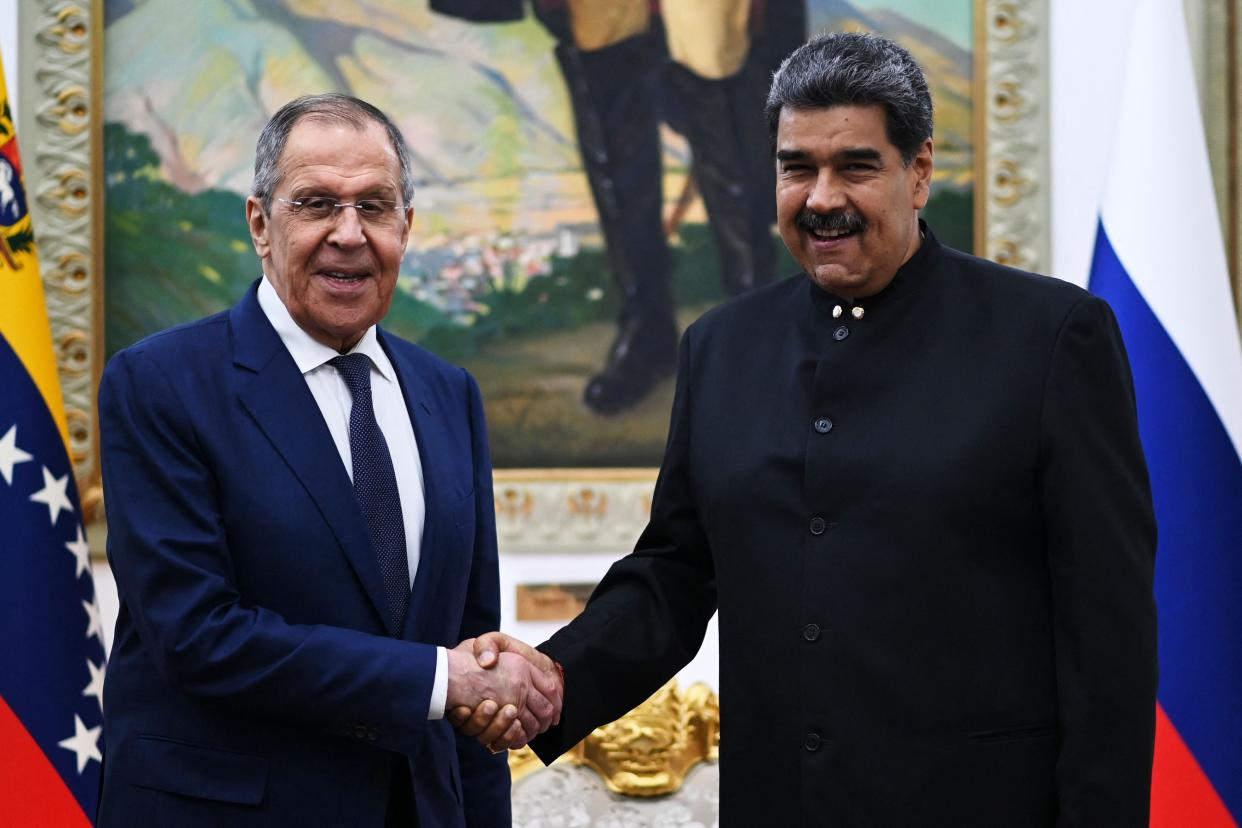 Lavrov and Venezuelan president Nicolas Maduro shake hands during a meeting at the Miraflores Presidential Palace in Caracas (AFP/Getty)