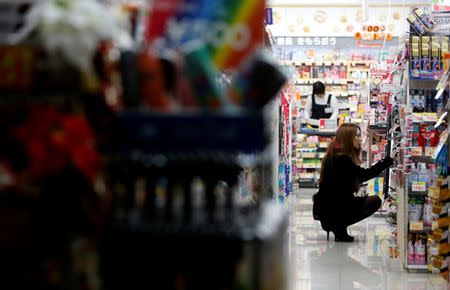 A woman looks at items at a pharmacy in Tokyo December 26, 2013. REUTERS/Yuya Shino/File Photo