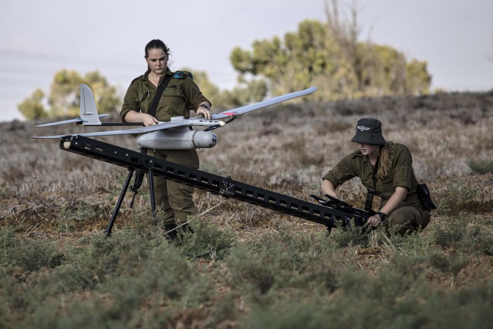 Israeli soldiers prepare to launch a drone near the border with Gaza Strip, Friday, Aug. 21, 2020. The Israeli military says Palestinian militants fired 12 rockets at Israel from the Gaza Strip overnight, nine of which were intercepted. (AP Photo/Tsafrir Abayov)