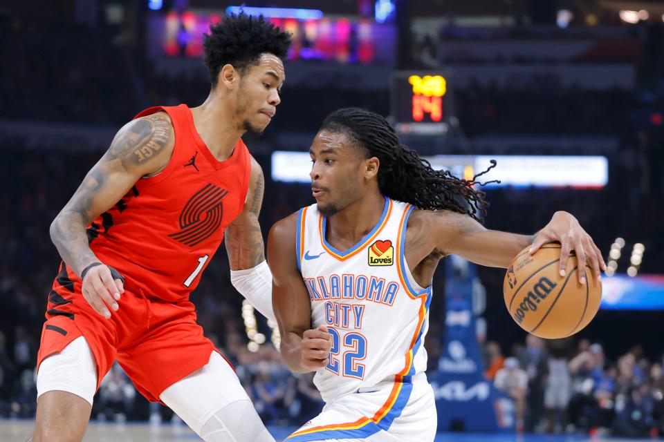 Oklahoma City Thunder guard Cason Wallace (22) drives past Portland Trail Blazers guard Anfernee Simons (1) during an NBA basketball game between the Oklahoma City Thunder and the Portland Trail Blazers at Paycom Center in Oklahoma City, Thursday, Jan. 11, 2024. Oklahoma City won 139-77.