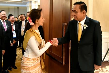 Myanmar's State Counsellor Aung San Suu Kyi shakes hands with Thailand's Prime Minister Prayuth Chan-ocha during their bilateral meeting in Bangkok