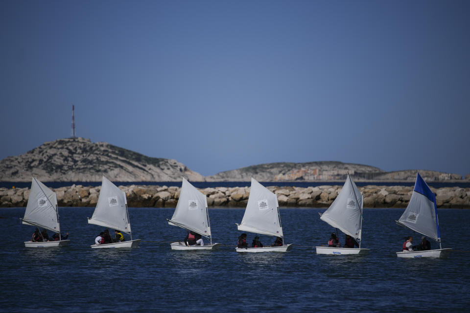 School children sail during a demonstration at the Roucas Blanc Marina constructed for the upcoming summer Olympic Games in Marseille, southern France, Tuesday, April 2, 2024. Marseille will host the Olympic sailing events during the Paris 2024 Olympic Games that run from July 26 to Aug.11, 2024. (AP Photo/Daniel Cole)