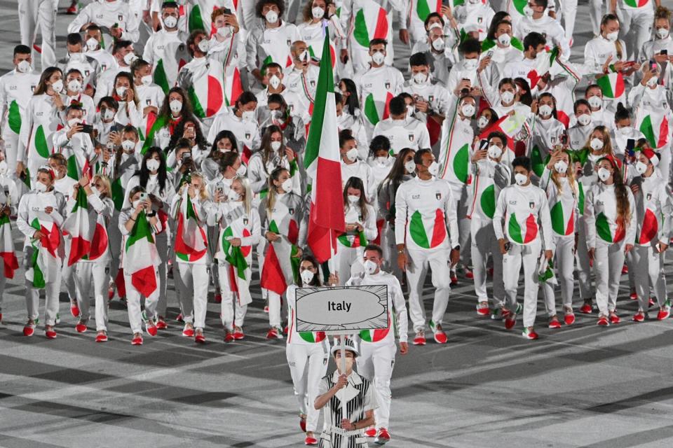 Italy's flag bearer Jessica Rossi (L) and Italy's flag bearer Elia Viviani lead the delegation during the opening ceremony of the Tokyo 2020 Olympic Games