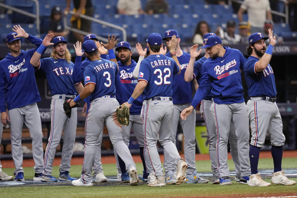 Texas Rangers players celebrate after defeating the Tampa Bay Rays in Game 1 of an AL wild-card baseball playoff series Tuesday, Oct. 3, 2023, in St. Petersburg, Fla. (AP Photo/John Raoux)