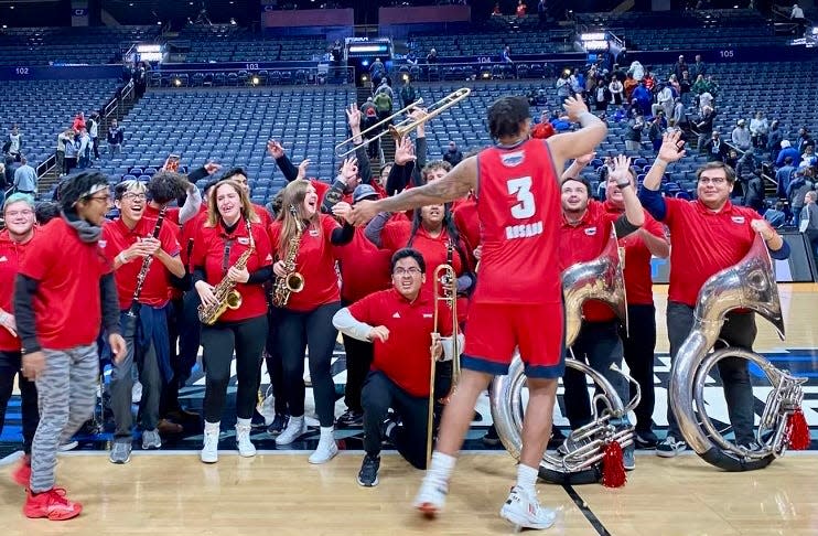 Florida Atlantic sophomore guard Giancarlo Rosado, a Palm Beach Lakes High School graduate, strikes up the band after the Owls' big win in New York to send the team - and the band - to Saturday's Final Four in Houston.