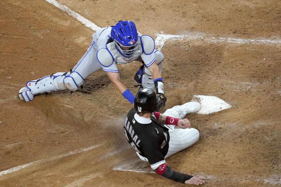 Toronto Blue Jays catcher Reese McGuire tags out Chicago White Sox's Yasmani Grandal at home during the fourth inning of a baseball game Wednesday, June 9, 2021, in Chicago. (AP Photo/Charles Rex Arbogast)