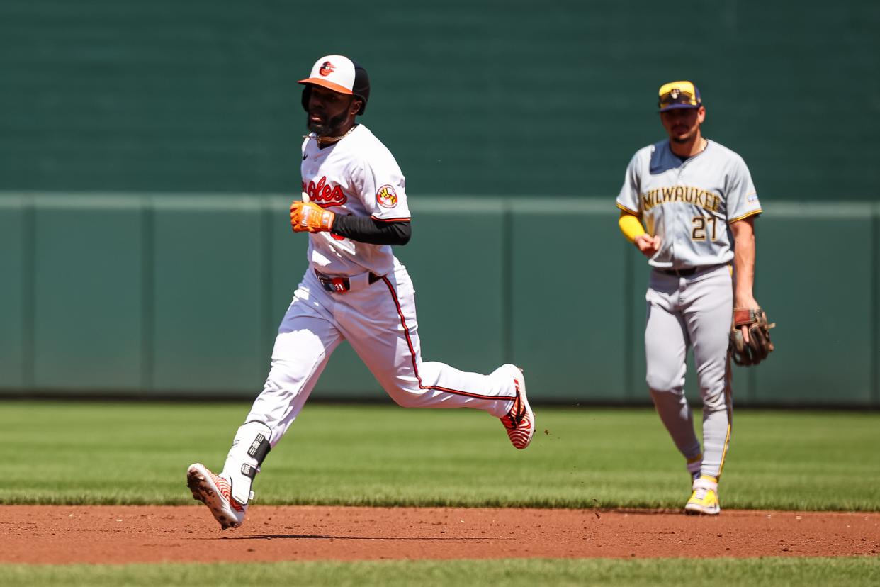 BALTIMORE, MD - APRIL 14: Cedric Mullins #31 of the Baltimore Orioles rounds the bases in front of Willy Adames #27 of the Milwaukee Brewers after hitting a home run during the second inning at Oriole Park at Camden Yards on April 14, 2024 in Baltimore, Maryland. (Photo by Scott Taetsch/Getty Images)