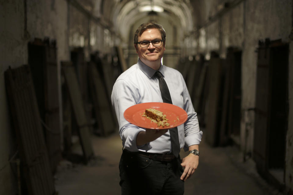 In this Friday, May 31, 2013 photo, director of public programming, Sean kelly displays a plate of Nutraloaf, presently served in Pennsylvania prisons as a “behavior modified meal,” at Eastern State Penitentiary in Philadelphia. The historic penitentiary plans to serve visitors sample meals from the 1800s, 1900s and today on June 8th and 9th. (AP Photo/Matt Rourke)