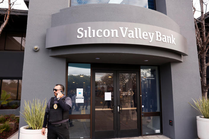 A security guard stands outside of the entrance of the Silicon Valley Bank headquarters in Santa Clara, California, U.S., March 13, 2023. REUTERS/Brittany Hosea-Small
