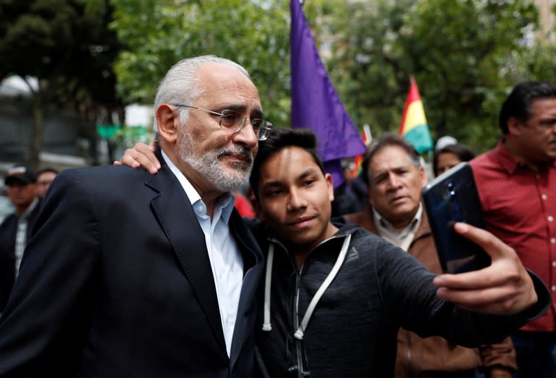 Carlos Mesa greets supporters after a news conference in La Paz