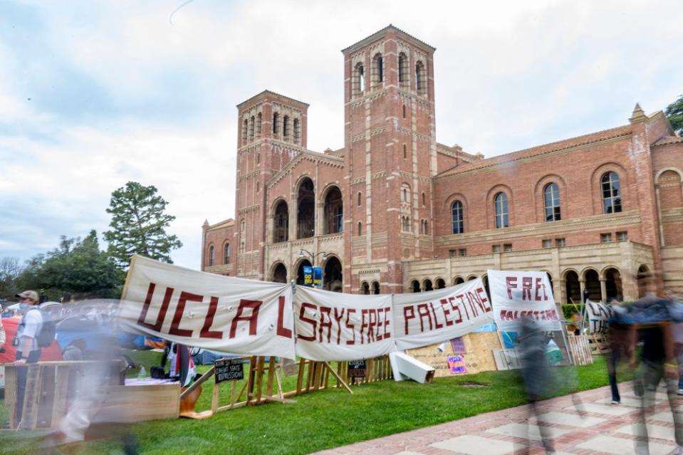 A poster reading “UCLA Says Free Palestine” hangs on the barrier of the pro-Palestinian encampment on April 25. The community expressed mixed sentiments toward the encampment, with some offering support and others voicing concerns. <span class="copyright">Julia Zhou for The Daily Bruin</span>