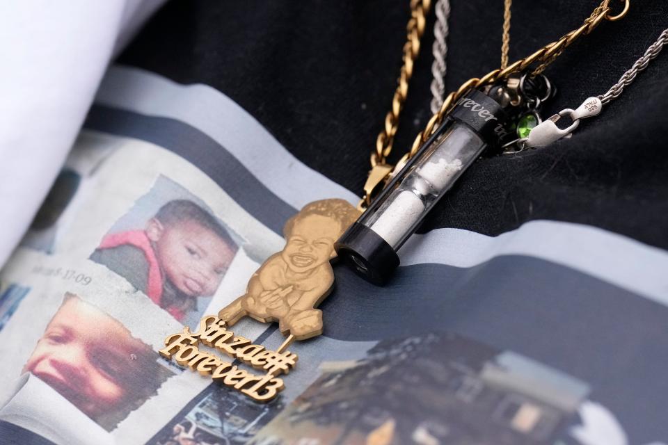 Sinzae Reed’s ashes are seen in a capsule around his mother Megan Reed’s neck while she speaks during a community press event regarding his shooting and subsequent death in Columbus, Ohio, on Jan. 1, 2023.