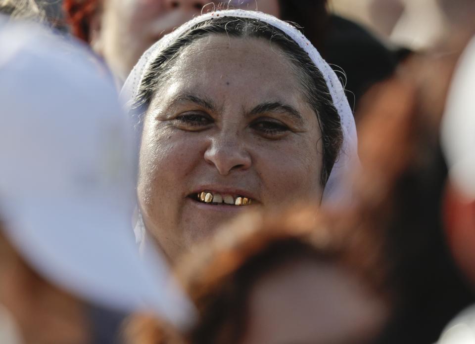 A woman waits to see Pope Francis during a meeting with young people and families, in Iasi, Romania, Saturday, June 1, 2019. Francis began a three-day pilgrimage to Romania on Friday that in many ways is completing the 1999 trip by St. John Paul II that marked the first-ever papal visit to a majority Orthodox country. (AP Photo/Andrew Medichini)